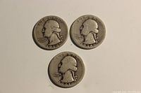 Obverse side of three Washington silver quarters, dates 1934, 1941, and 1944, showing George Washington's profile with visible wear.