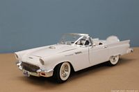 White 1/18 scale diecast model of 1957 Ford Thunderbird outside of the box showing front and side profile.
