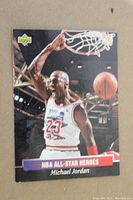 Front side of a Michael Jordan 1992-93 NBA All-Star Upper Deck trading card showing him dunking with a clear arena background and Upper Deck logo