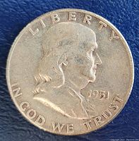Obverse side of 1951 Franklin Half Dollar showing Benjamin Franklin profile, date, and inscriptions.