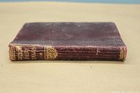 Side view of the book's spine showing maroon cover with gold embossed title 'Grimm's Fairy Tales' and Collins imprint.