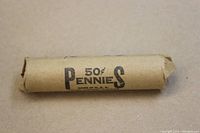 Photo of wheat penny roll wrapped in brown paper showing printed '50¢ Pennies Made in U.S.A.' text.