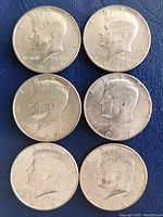 Obverse side of six Kennedy Half Dollar coins from 1966, 1967, and 1968 showing profiles of John F. Kennedy with clear date markings.