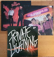 Front covers of three 1980s Boston rock band vinyl albums by The Stompers, The Fools, and Private Lightning.