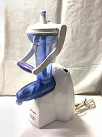 Front and side view of the Black & Decker Arctic Twister Soft Ice Cream Maker with visible hand crank and power cord.