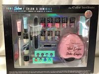 Front view of the sealed 21-piece nail polish set including nail dryer, multiple nail polishes, and nail care accessories in clear packaging.