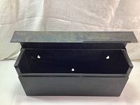 Photo of the mailbox interior showing the open top lid and mounting holes.