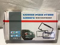 Box showing product branding as a waterproof license plate frame camera with color CCD sensor and light activated switch.