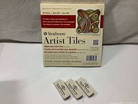 Pack of 10 Strathmore Artist Tiles with 3 new white Alvin artist erasers in front.