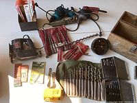 Overview of jig saw, drills, drill bits, and soldering gun kit on table