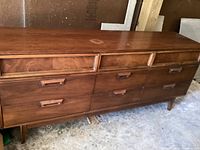 Full view of six drawer wooden dresser showing design and finish