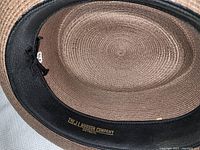 Inside crown of light brown straw hat showing label and size 7 1/8
