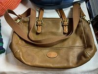 Brown leather Fossil shoulder bag with adjustable strap and two handles