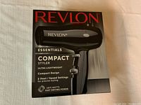 Front of box showing the Revlon Essentials Compact Styler hair dryer with specs