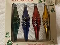 Box of 4 Aldersbrook long, tapered vintage Christmas ornaments in green, blue, red, and gold with silver glitter decorations