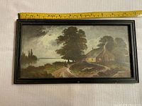 Front view of the rectangular landscape painting featuring a house, trees, path, and water body. Black wooden frame surrounds the artwork.