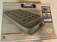 Box showing Bestway twin air mattress with built-in pump, size 74x39x12 inches.