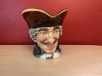 Front left angle of the Dick Turpin Toby Jug showing detailed facial features and hat shape.