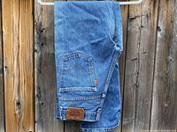 Levi's 505 jeans folded showing orange tab and leather patch