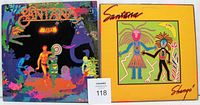 Photo showing the front covers of two Santana vinyl LP albums, Amigos and Shango, placed side by side with a Maxsold auction number card visible.