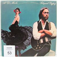 Front cover of the album Elegant Gypsy by Al Di Meola. Shows artist and woman in black dress, album title and artist name on teal background.