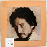 Front cover of Bob Dylan New Morning LP album jacket, peach color with black and white photo of Bob Dylan.