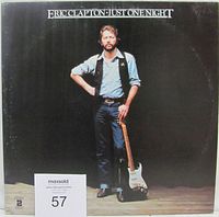Front cover of Eric Clapton Just One Night vinyl double LP album with image of Eric Clapton standing with guitar on stage.