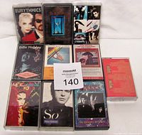 Photo of 10 cassette tapes arranged in three rows showing front covers and one back insert.