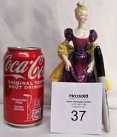 Photo showing figurine next to Coca-Cola can and marker for scale, indicating approximately 8 inches height