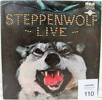 Front cover of Steppenwolf Live double LP album, showing snarling wolf image as artwork with album title in studded text.