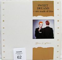 Front cover of the vinyl record sleeve with title Sweet Dreams Are Made Of This by The Eurythmics, image of two figures, white/gold color scheme.