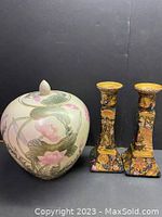 Full shot of the ginger jar and the pair of candlesticks showing their relative sizes and front designs