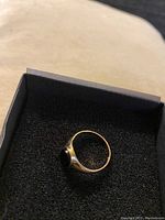 Side view of ring in black jewelry box showing overall shape and style