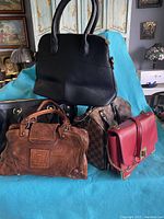 Front view of all five bags displayed on blue background