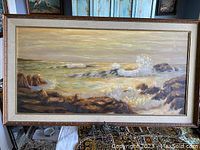Frontal view of the large ocean coastal landscape painting in frame showing full artwork and size context.