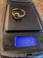 Photo of the ring on a digital scale showing the weight as 2.1 grams.
