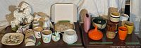 Image of assorted ceramic, pottery, and glass decor including horse figurines, cups, and a boxed plaque