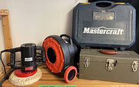 Mastercraft router/spin saw in case, air blower, green toolbox, and other tools on shelf.
