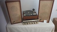 Full view showing Eico amplifier, turntable record player, and two KLH speakers on a table.