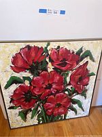 Full view of the original painting of red flowers on canvas framed in wood, showing vibrant red petals and green leaves against textured white-yellow background.