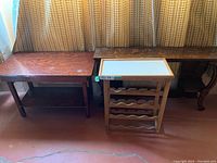 Three separate pieces side by side showing the rustic table, wine rack with whiteboard top, and ornately carved wooden console table.