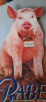 Die-cut pig figure from the movie 'Babe' with collar and name tag