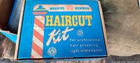 Blue box lid showing 'Manning Bowman Haircut Kit' branding and professional grooming statement.