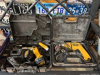 Two Dewalt drills shown in their open plastic cases with charger and accessories.