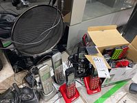 Overview of cordless phones including two Panasonic and two VTech phones with accessories in a box