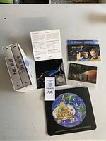 Overview of all items including two Star Trek Blu-ray box sets, silver coin in case with certificate, postage stamps, and souvenirs.