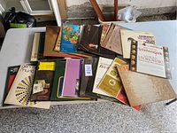 Table with a spread of assorted classical music vinyl records with visible titles including Rachmaninoff, Stokowski, and others.