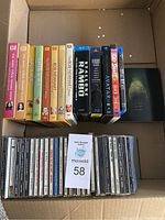 Box with DVDs and CDs, shows full assortment and arrangement