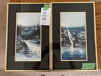 Front view of two framed paintings by Serge Paque with labels and tag visible