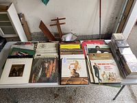Full view of vinyl records and CDs on a table showing album covers, featuring composers and orchestral music.